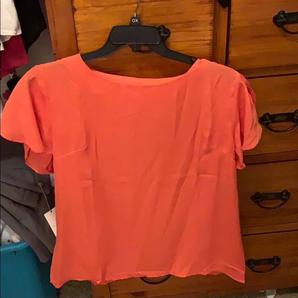 Coral blouse with ruffle sleeves
